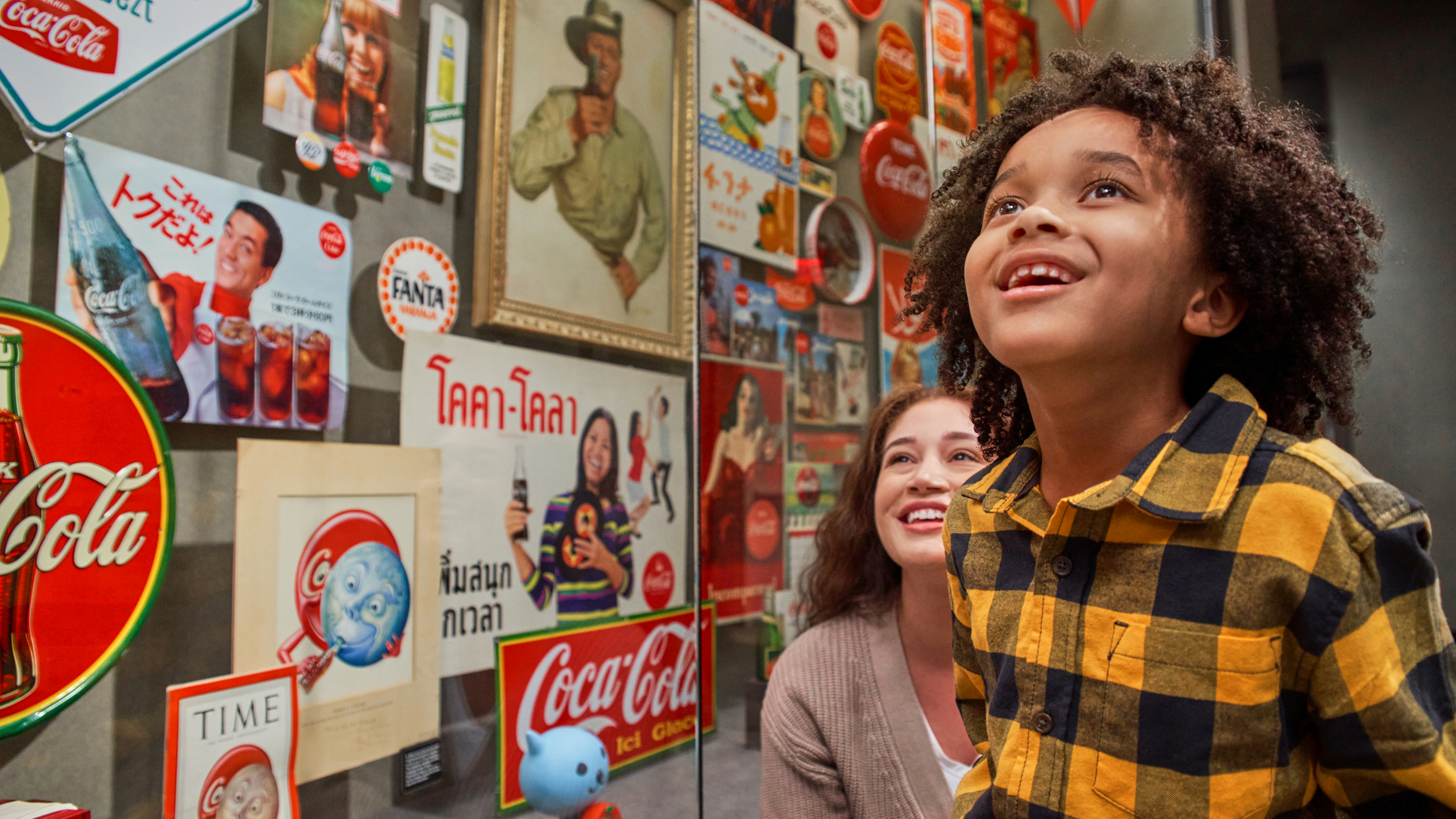 Kid looking at World of Coca Cola exhibit