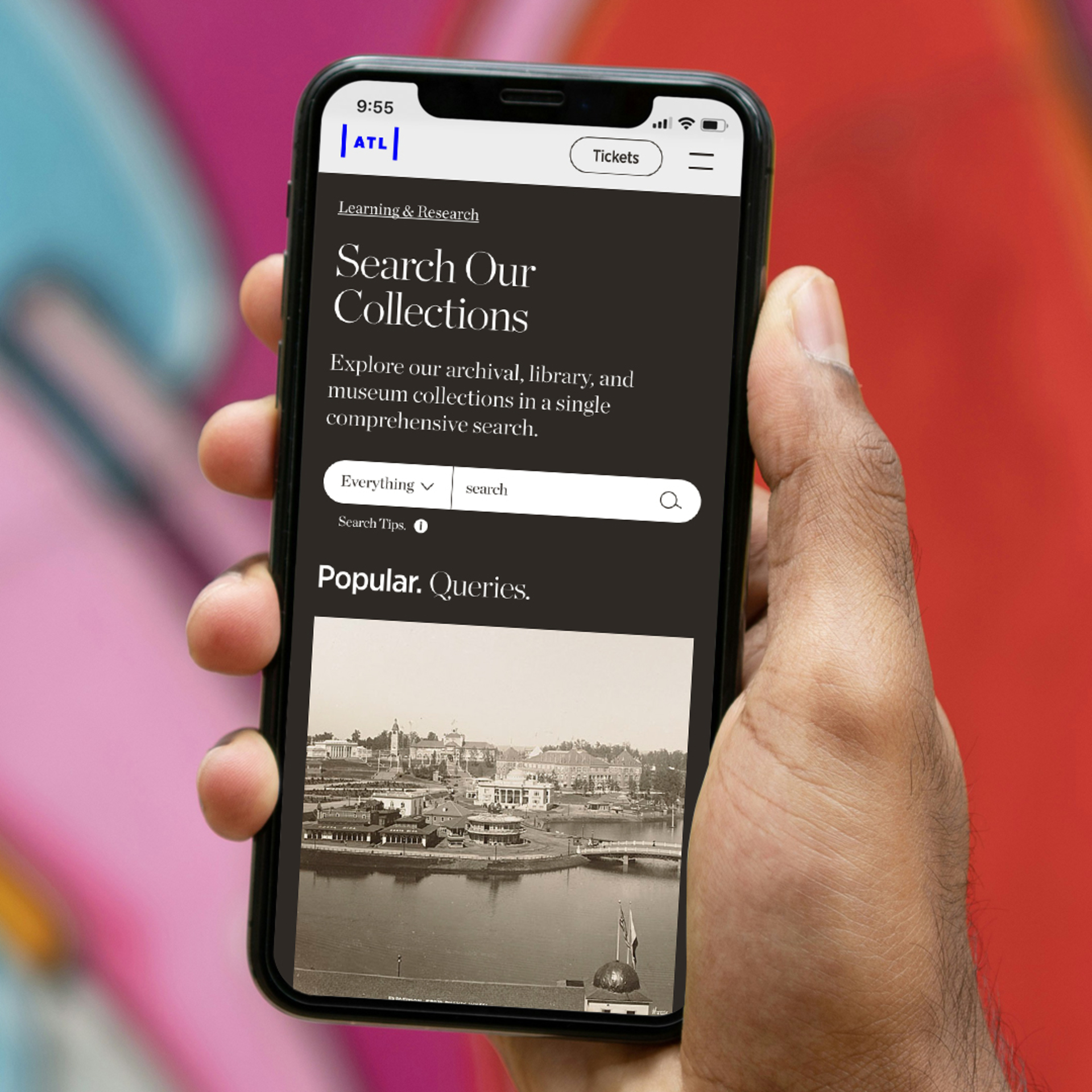 A hand holds a mobile phone displaying the Atlanta History Center's federated search application