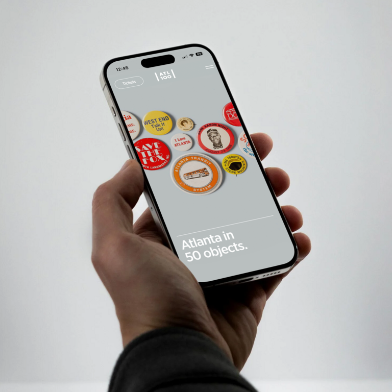 An image of someone looking at the AHC designed and built website on a mobile device.