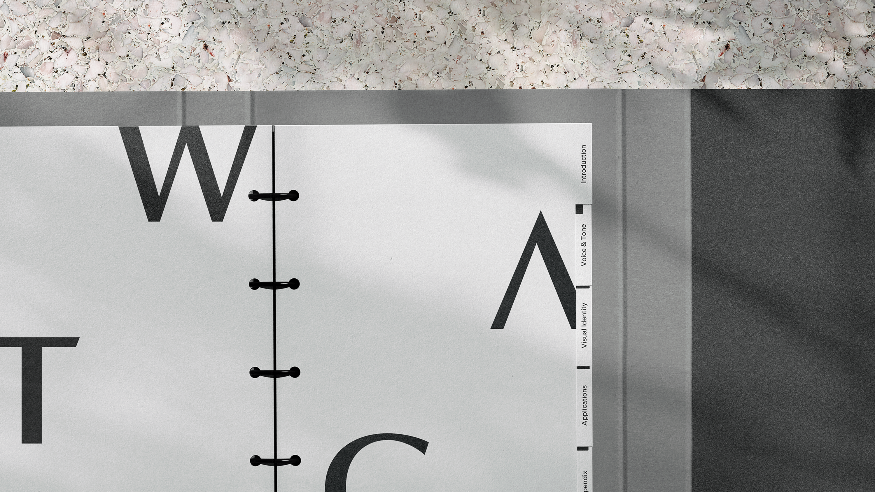 A detailed photo of the WATG visual identity system binder.